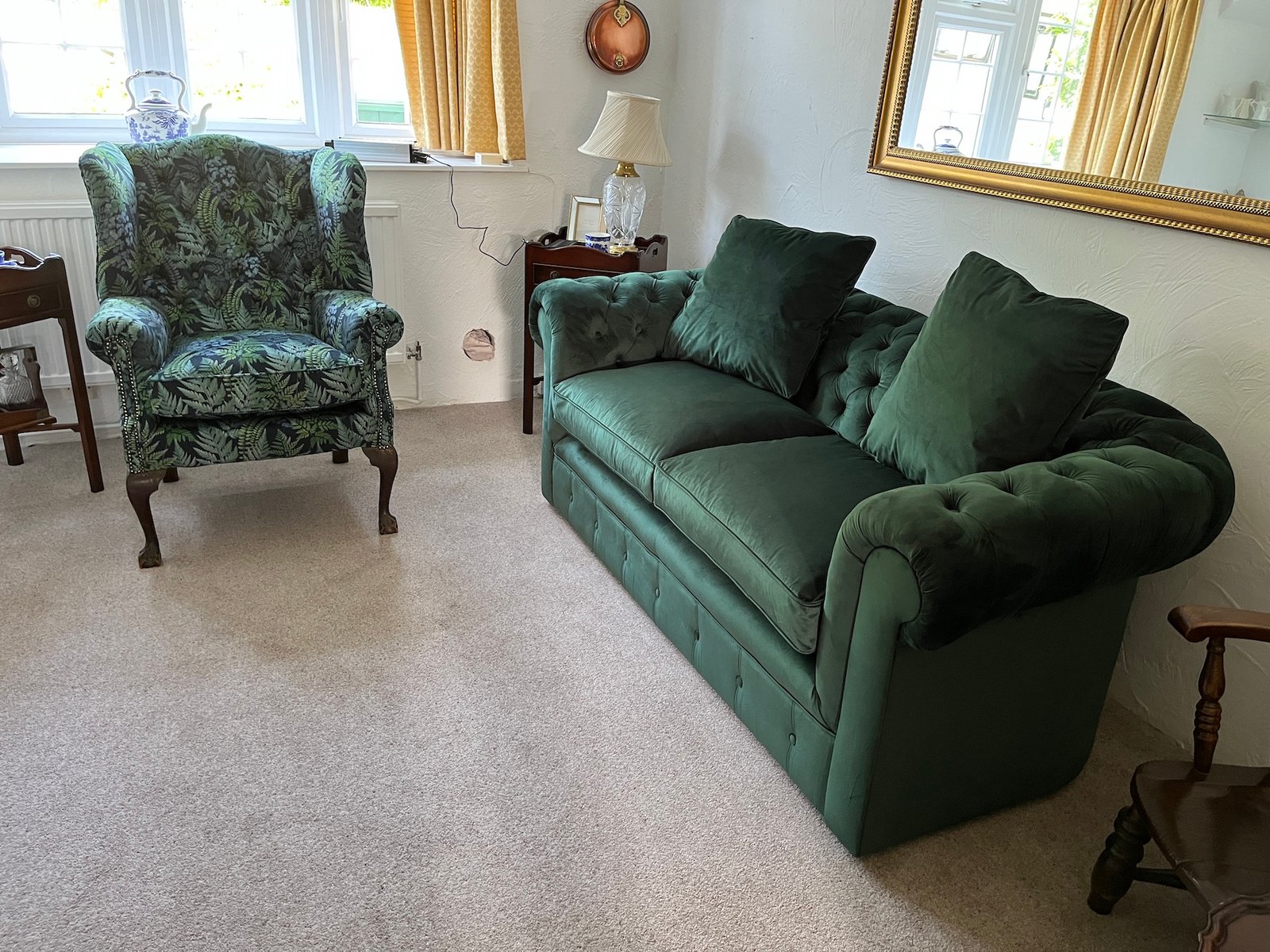 Green two-seat sofa with matching armchair