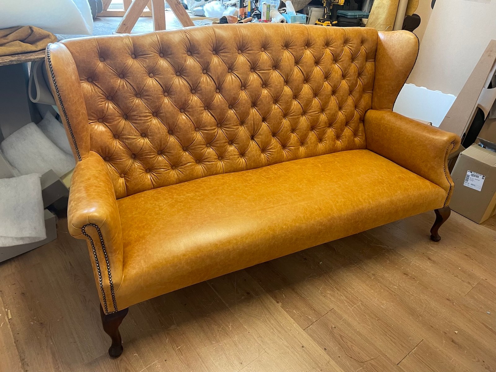 Tan leather button-back high-back settee