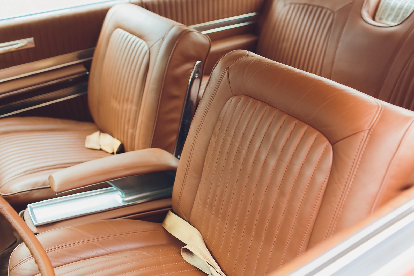 Tan leather car interior with front and rear seats
