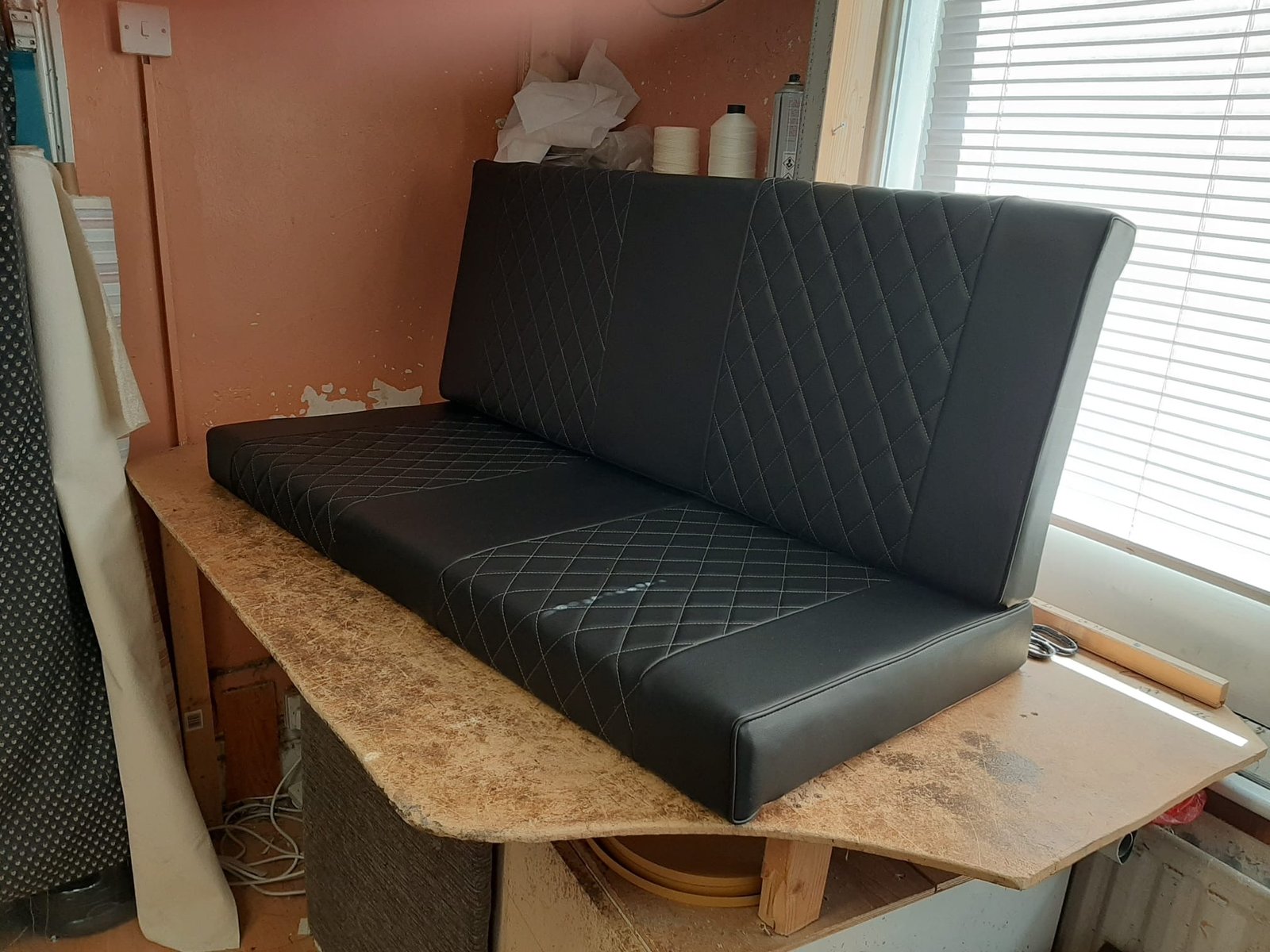 Black channelled camper bench on worktable