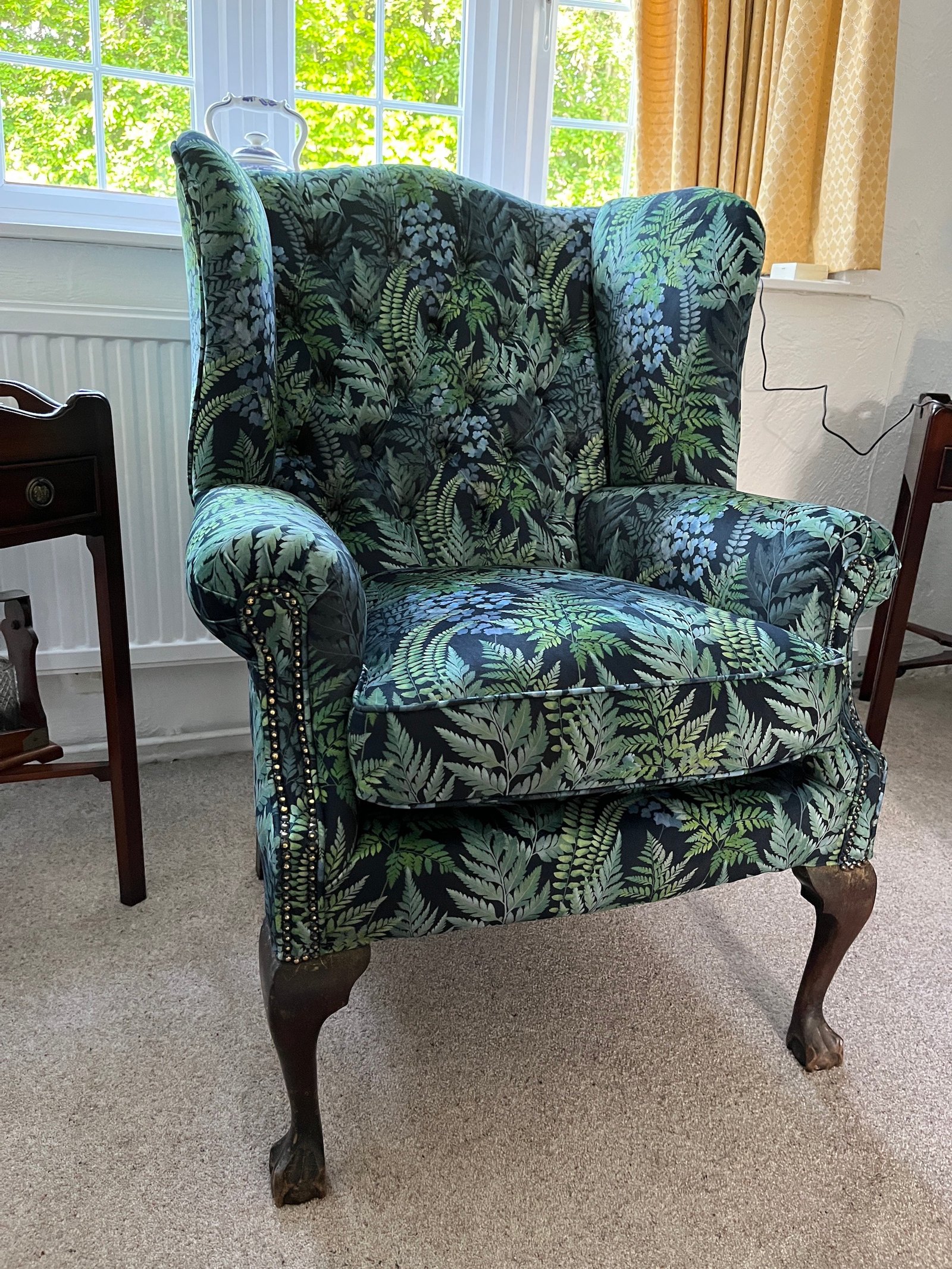Floral wingback chair with dark patterned fabric