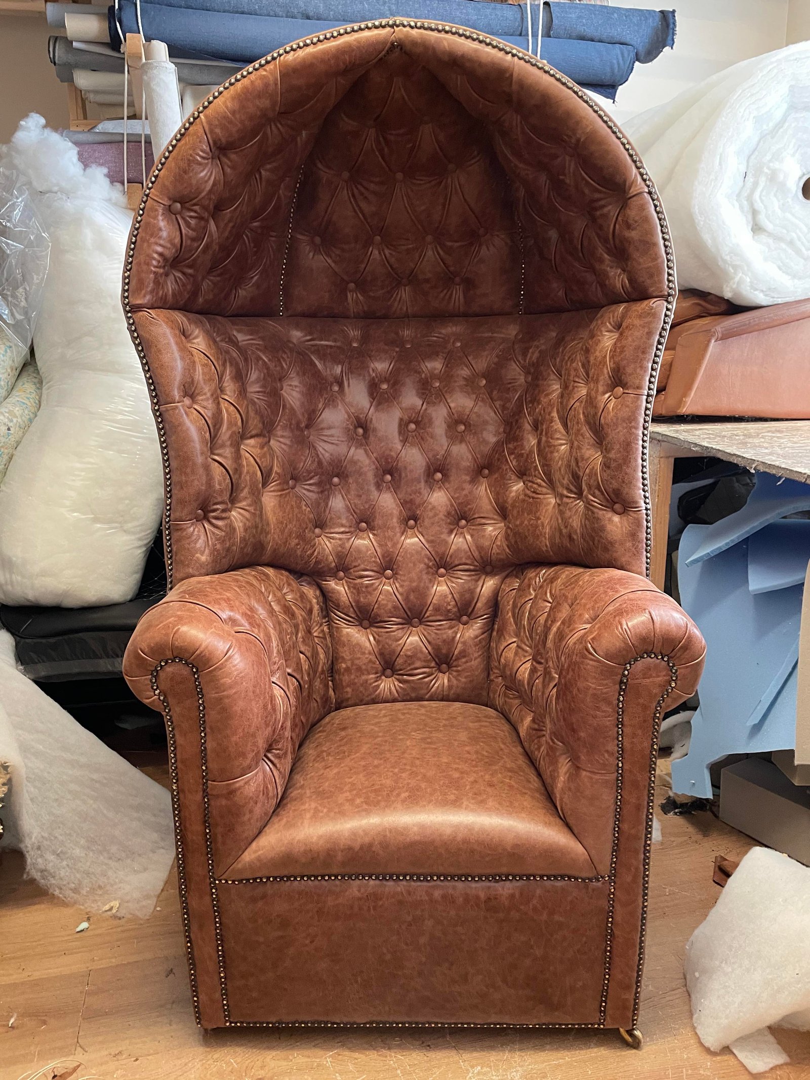 Brown leather-look wingback or porter chair