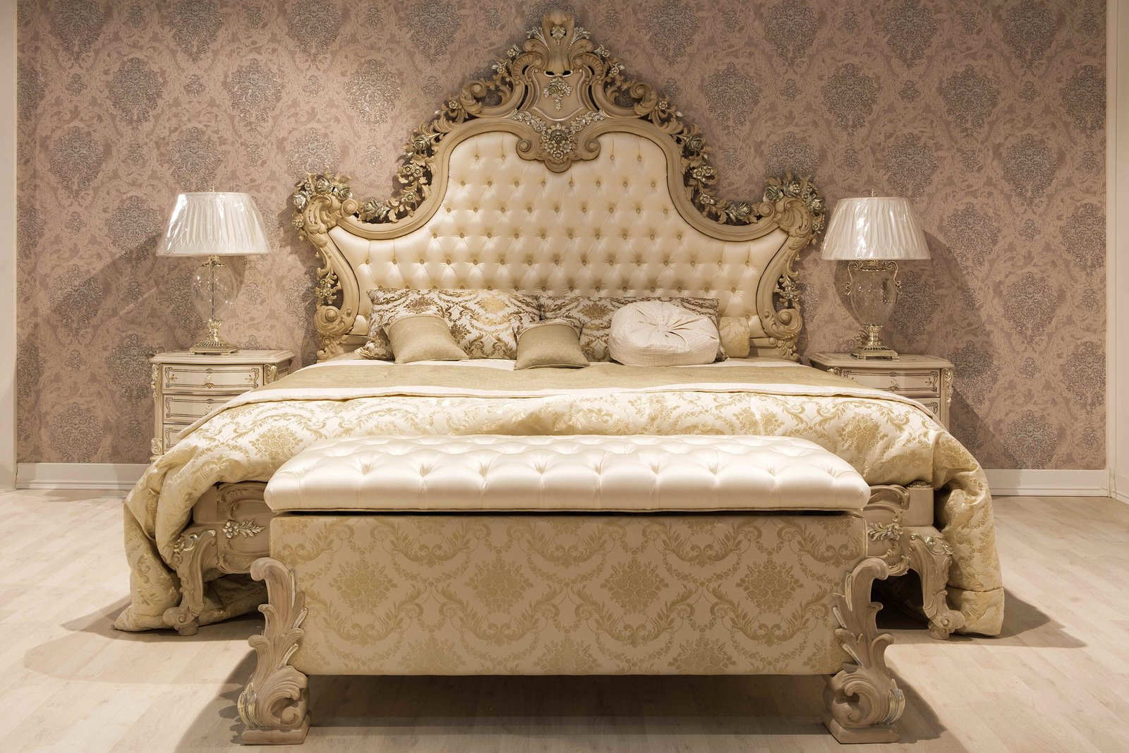 Ornate cream and gold upholstered bed and headboard