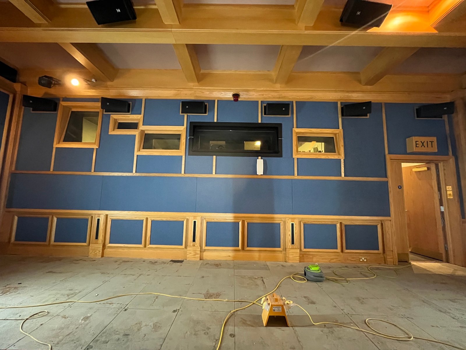 Large finished blue-and-gold upholstered wall panel installation