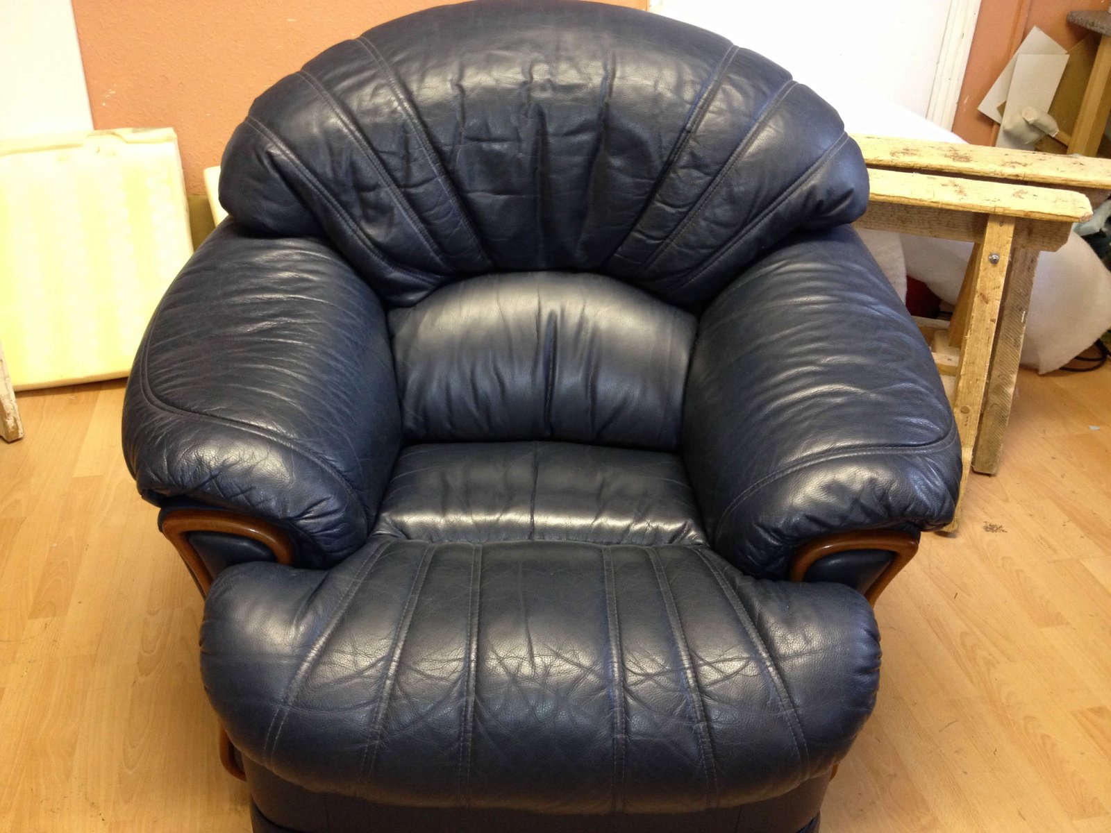 Finished black leather armchair after repair