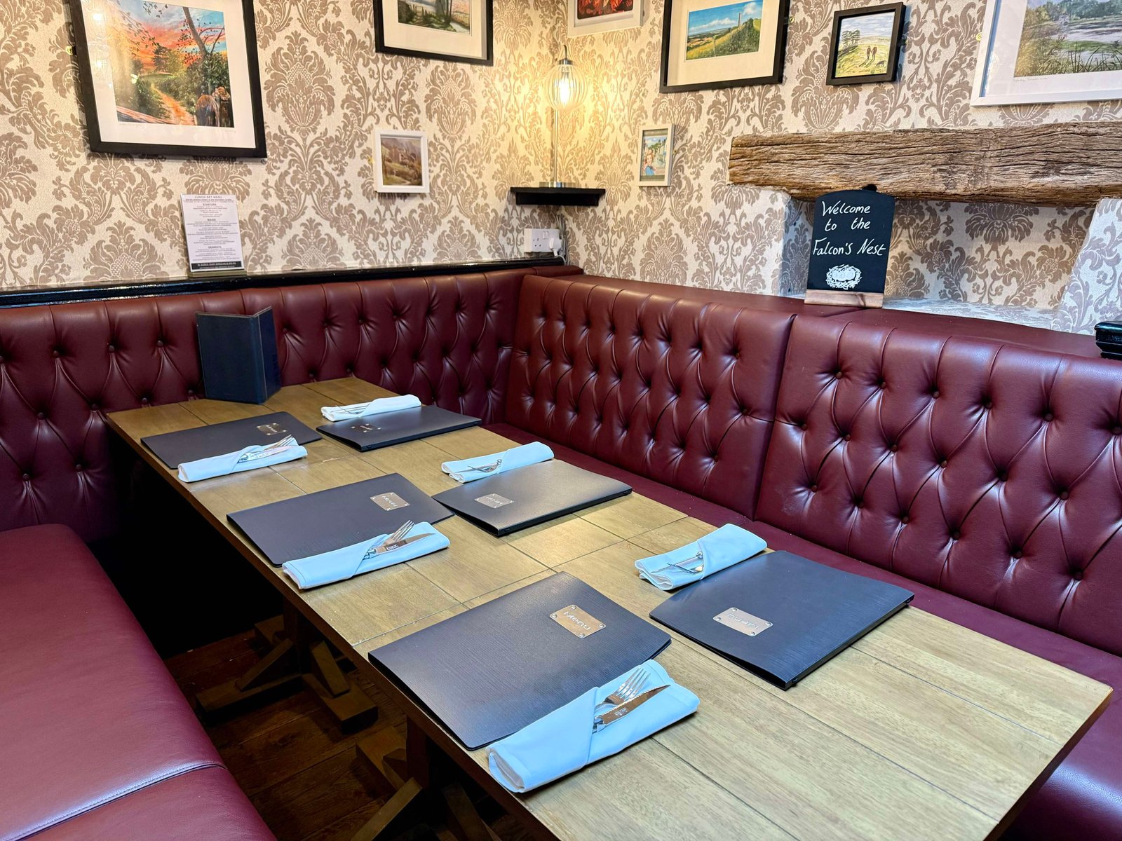 Burgundy buttoned restaurant booth with tables set
